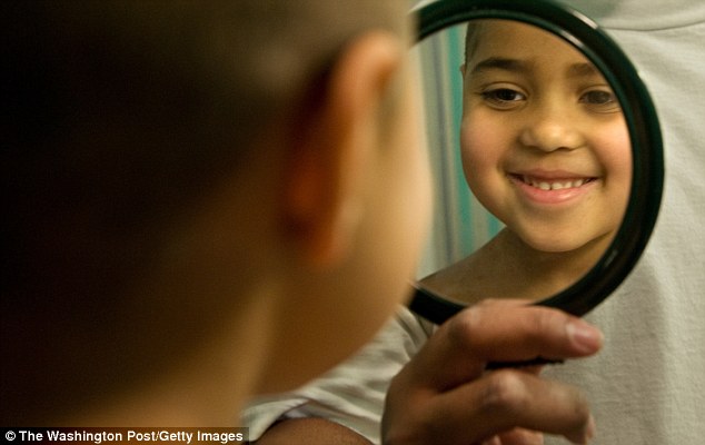 A child looking in a mirror